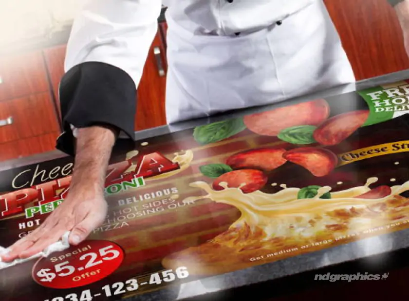 A chef wiping down a graphic on the counter