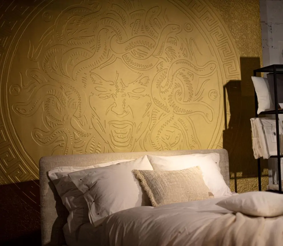 Bedroom wall with gold emblem printed on Dimense Print Wallcovering