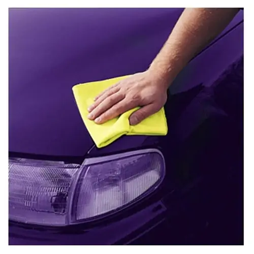 Hand using yellow 3M Detail Cloth wiping the front fender of a purple car.