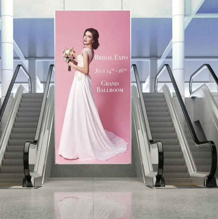 Escalators with a pink sign with a girl in a wedding dress 