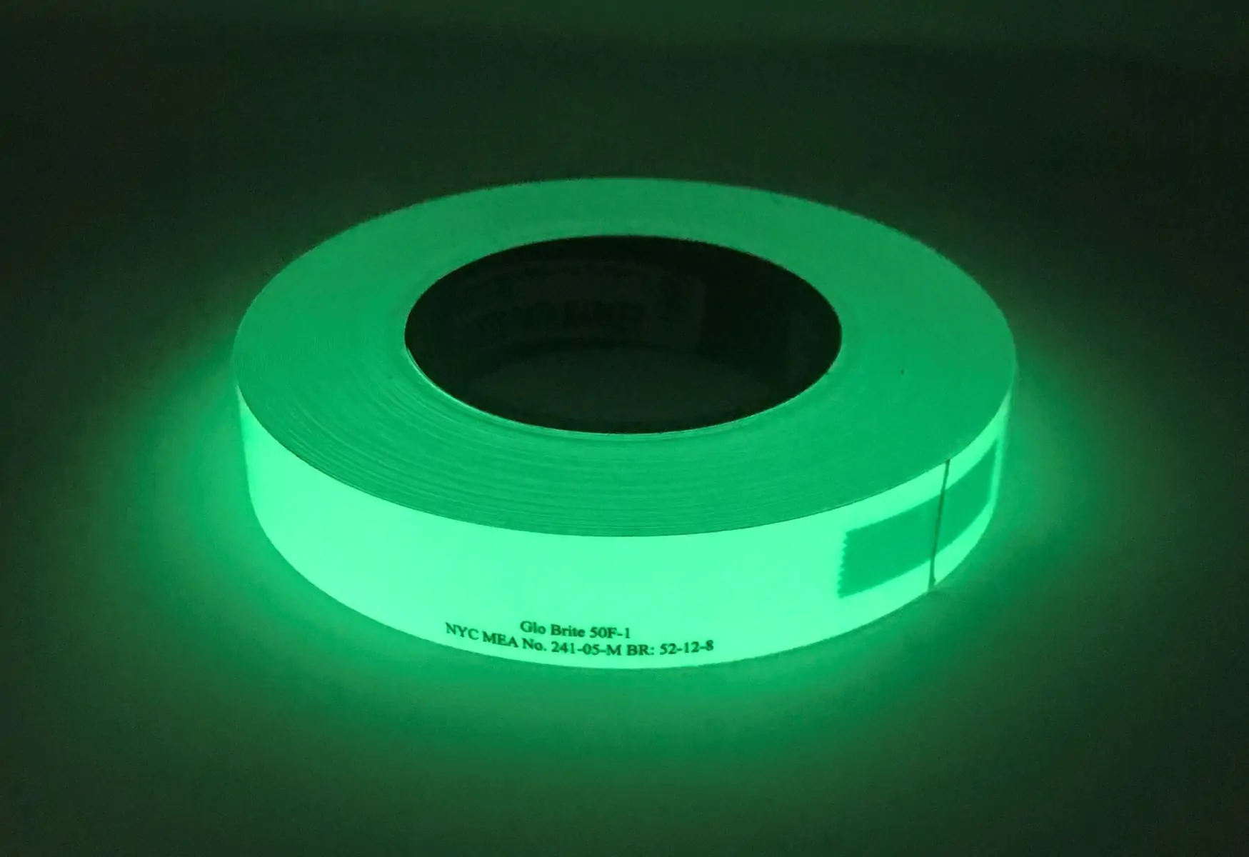 A white tap glowing in green 