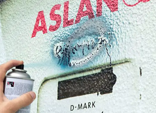 SL 99 deflecting spray paint on a textured wall