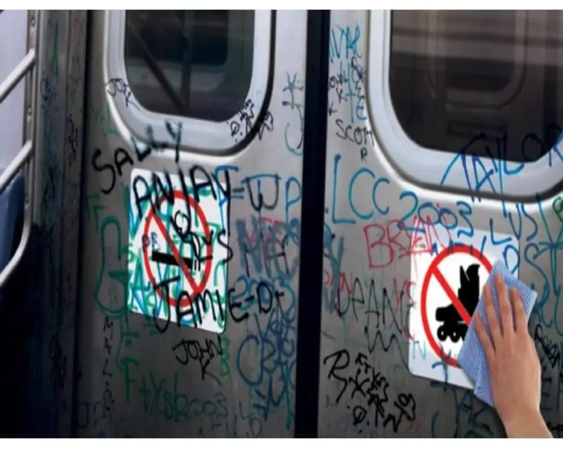 Person wiping off graffiti on subway doors and 7248 Anti-Graffiti Overlaminate