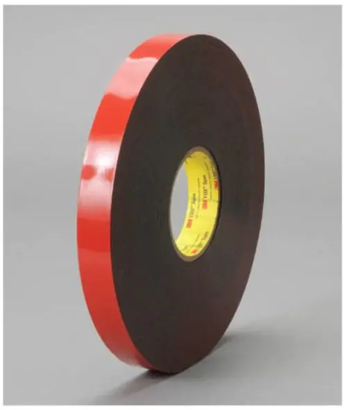 Roll of 3M 5952 VHB Black Acrylic Foam Tape with red exterior and yellow core on grey background.