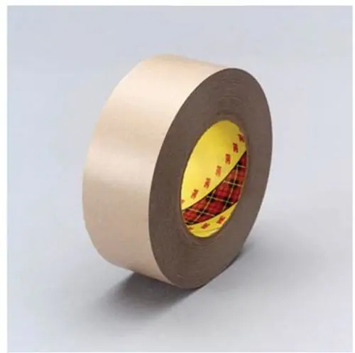 Brown roll of 3M 9471 Laminating Adhesive with yellow and red core on grey background.