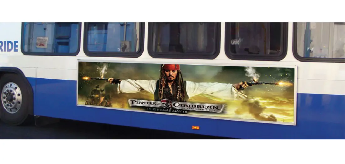 "Pirates of the Caribbean" film advertisement on blue and white bus.