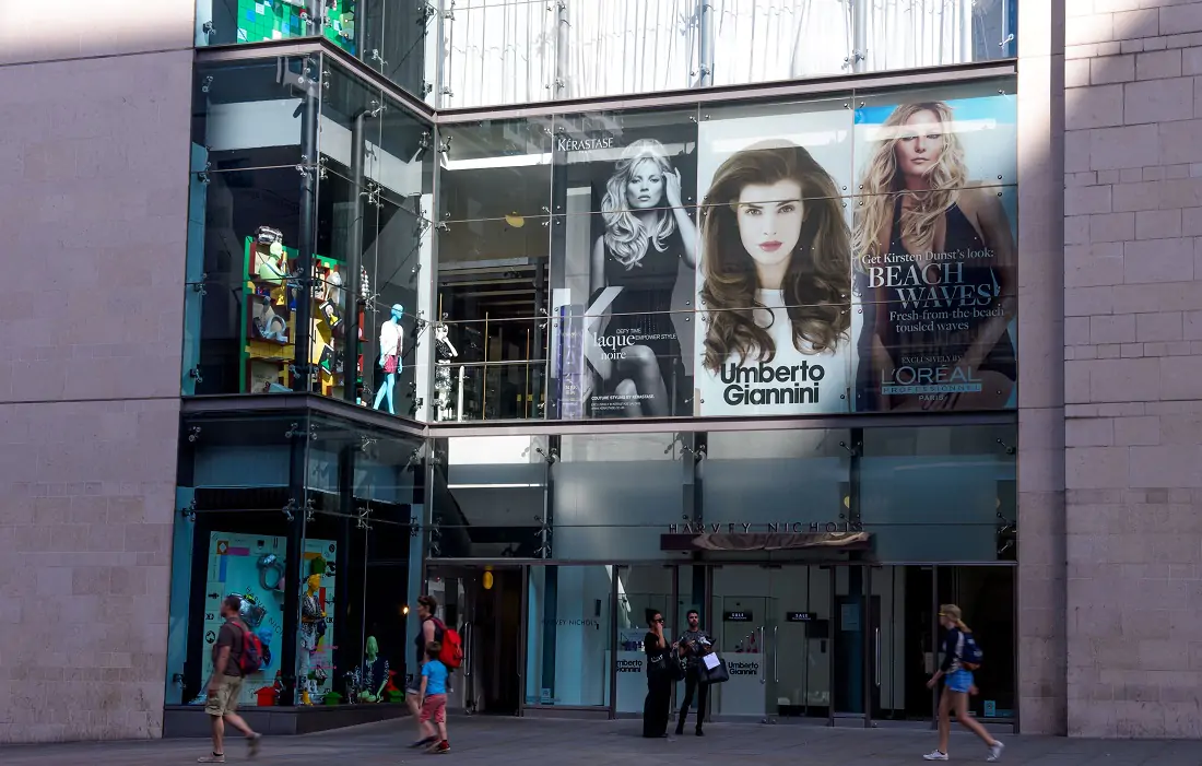 A building with posters of 3 different women advertising companies 