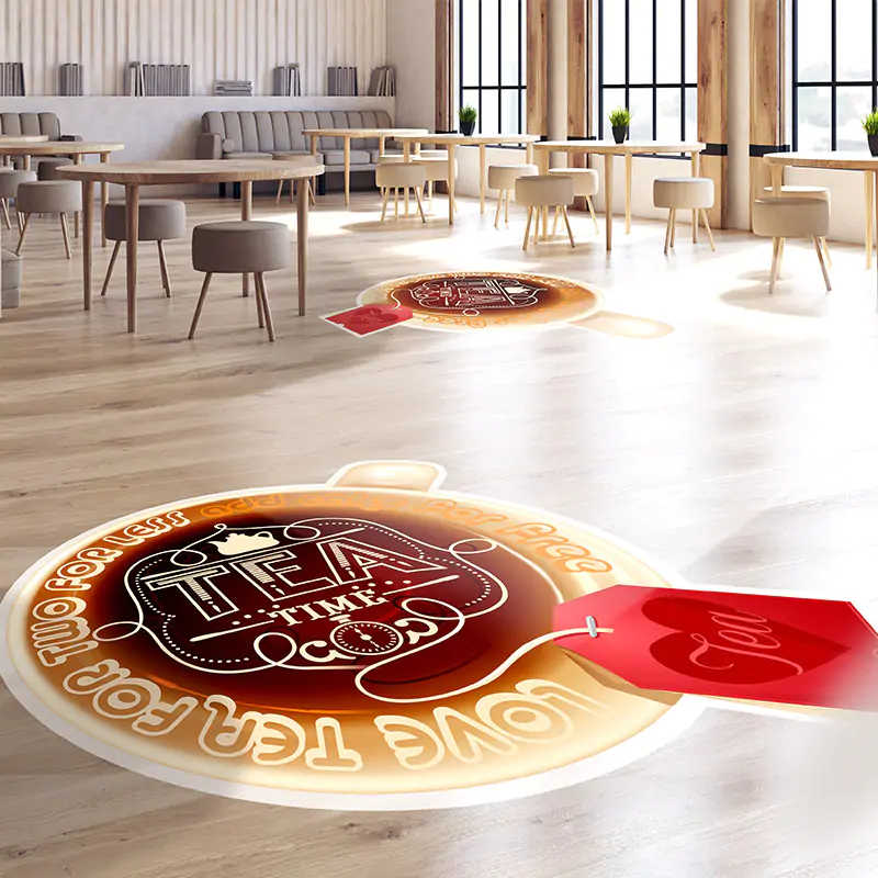 Two red and yellow, circular floor advertisements reading "Tea Time" in centre of large dining space.