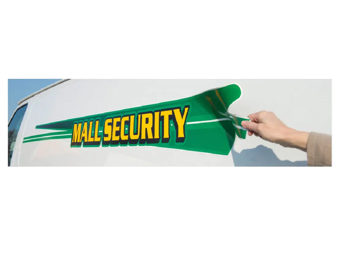 Green and yellow "Mall security" decal on the side of a white van