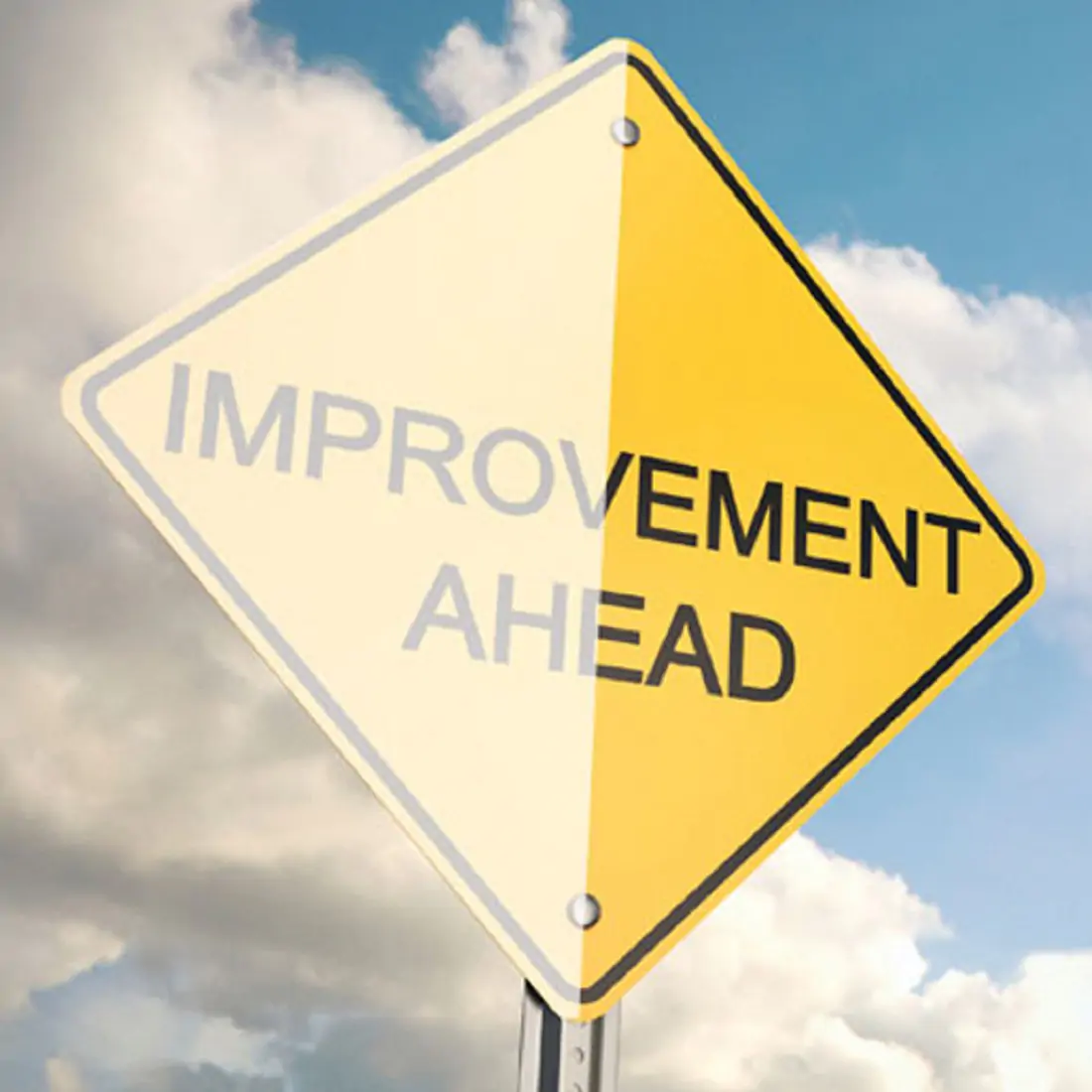 Yellow road sign "Improvement Ahead" half with strikeguard laminate, half without