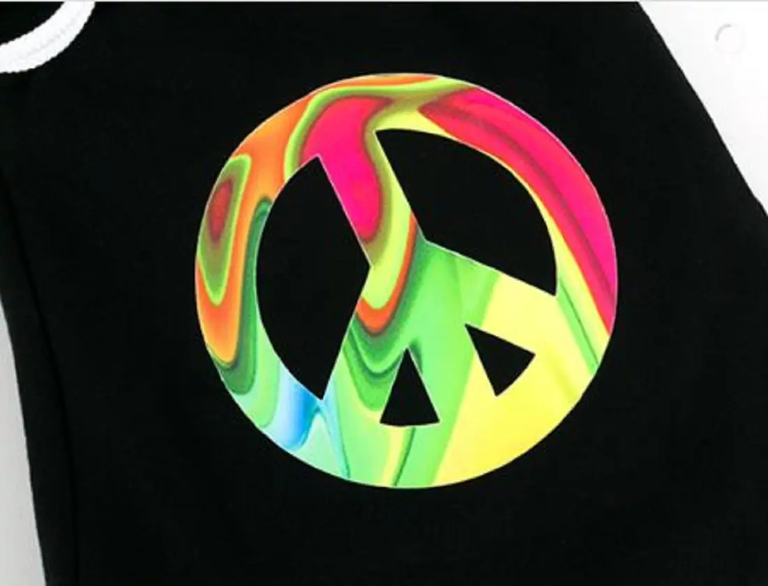 A black background with a multi-coloured tye dye peace sign printed on 
